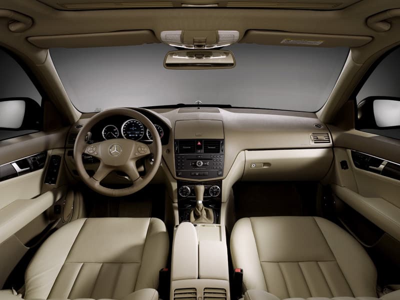 Interior view showing beige dashboard and steering wheel