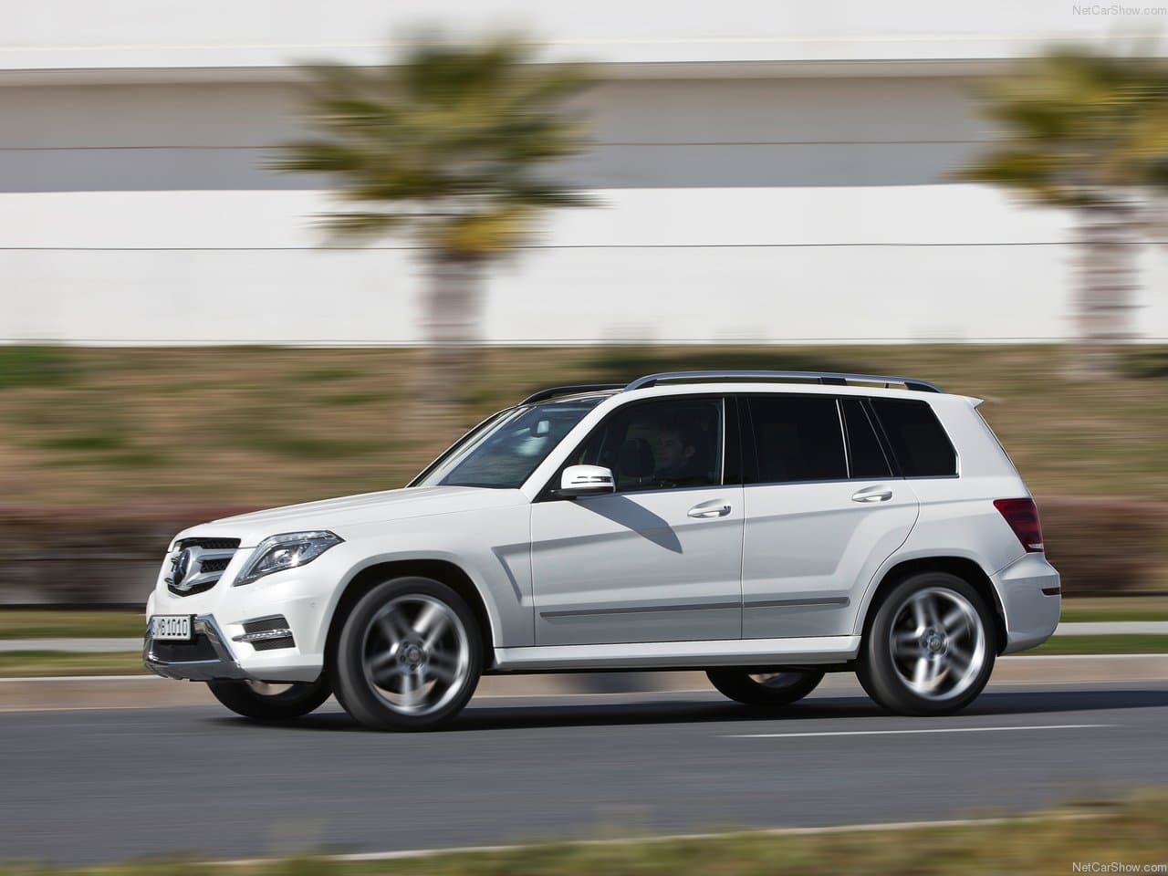 Side profile driving fast past palm trees